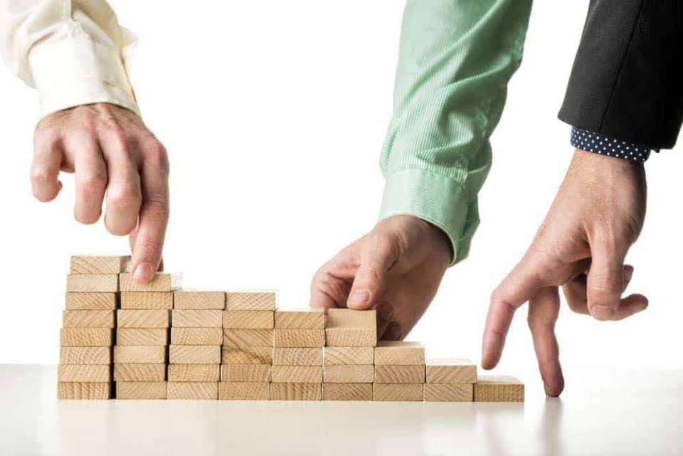 Stairs from wooden blocks with hands